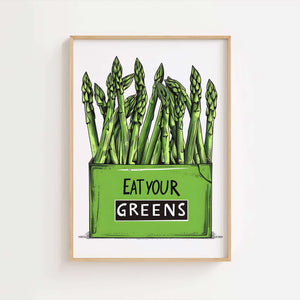 Køkkenplakat med grønne asparges og teksten "Eat Your Greens" i en træramme – sjov og farverig vægdekoration til køkkenet.