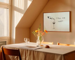 Minimalistisk vinplakat med stregtegning af vinflaske og glas samt teksten “Tell Me When”.