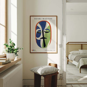 Plakat med farverigt stiliseret ansigt inspireret af Henri Matisse i blå og grønne former