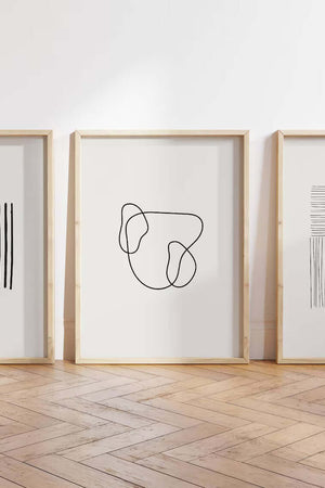 Minimalistisk billedvæg med tre moderne line art plakater i sort og hvid